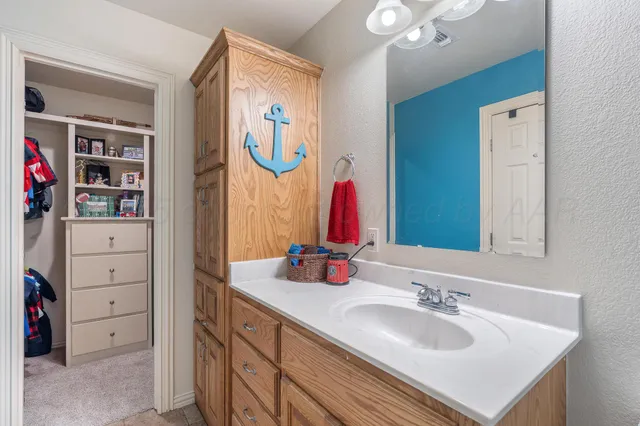 a bedroom with two beds and a lamp