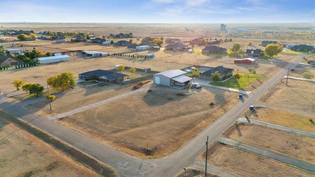 a view of a patio with couches table and chairs with wooden floor and fence