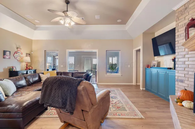 a living room with furniture a flat screen tv and fireplace