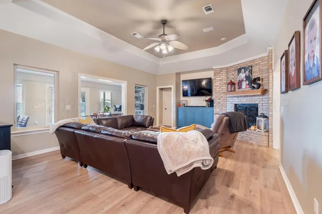 a kitchen with stove a refrigerator and chairs