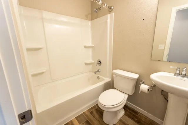 a bathroom with a toilet sink and shower