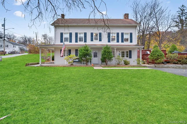 a front view of a house with a yard table and chairs