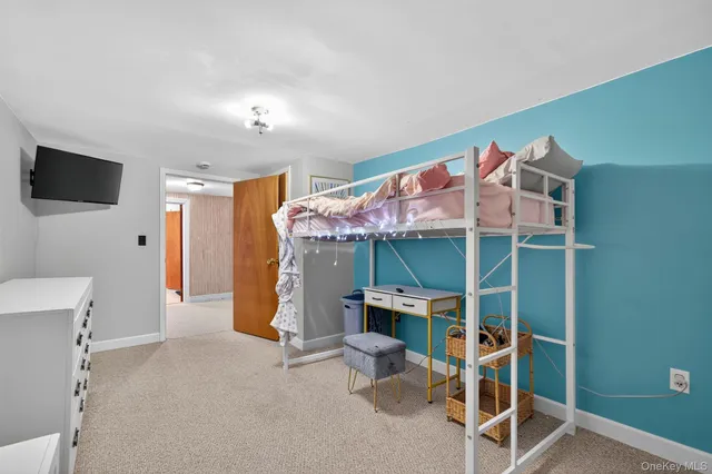 a view of a room with furniture and a flat screen tv