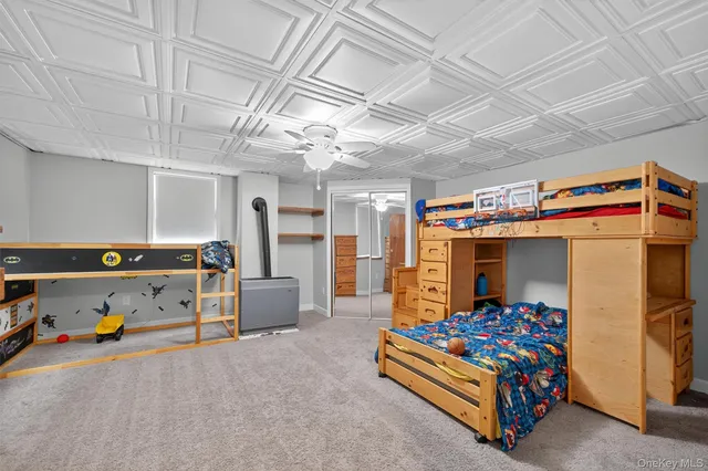 a view of an empty room with a window and hardwood floor