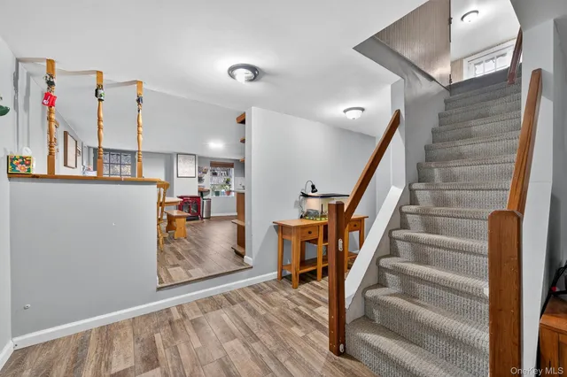 a view of entryway with wooden floor and stairs