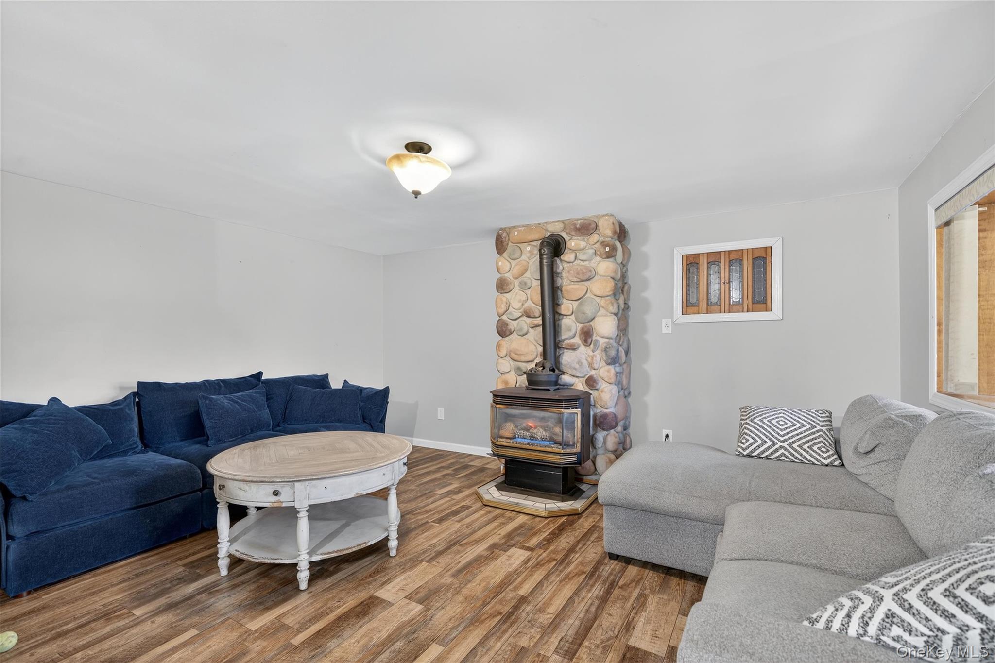 493 Gate Hill Coop Road Stony Point, NY 10980 - Photo 9 of 33 a living room with furniture a couch and a bookshelf with wooden floor