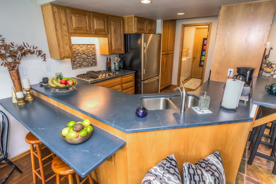 17691 Bittern Lane Sunriver, OR 97707 - Photo 4 of 18 The kitchen is laid out perfectly for entertaining and looks out across the living area towards the pool and common area.