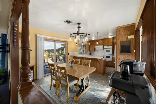 a view of a dining room with furniture window and outside view