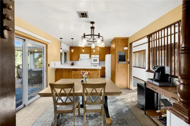 a kitchen with stainless steel appliances a stove center island a refrigerator and cabinets