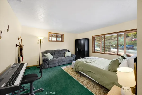 a bedroom with a bed and a large window