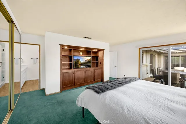 a roof deck with table and chairs and wooden floor
