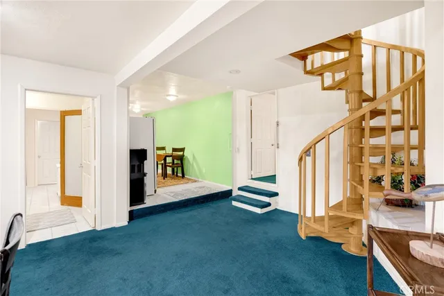 a kitchen with a refrigerator and white cabinets