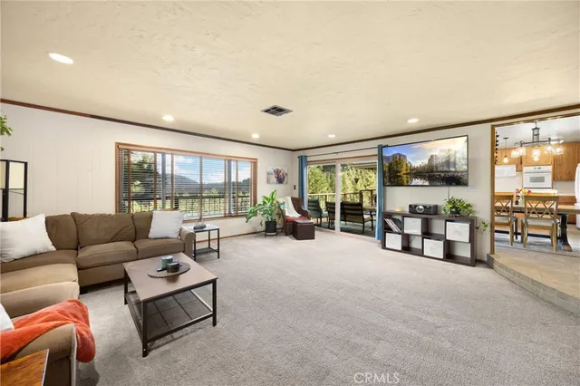 a bedroom with a bed chair and painting on the wall