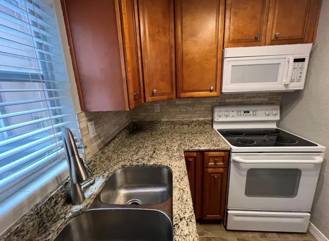 a kitchen with a stove and a sink