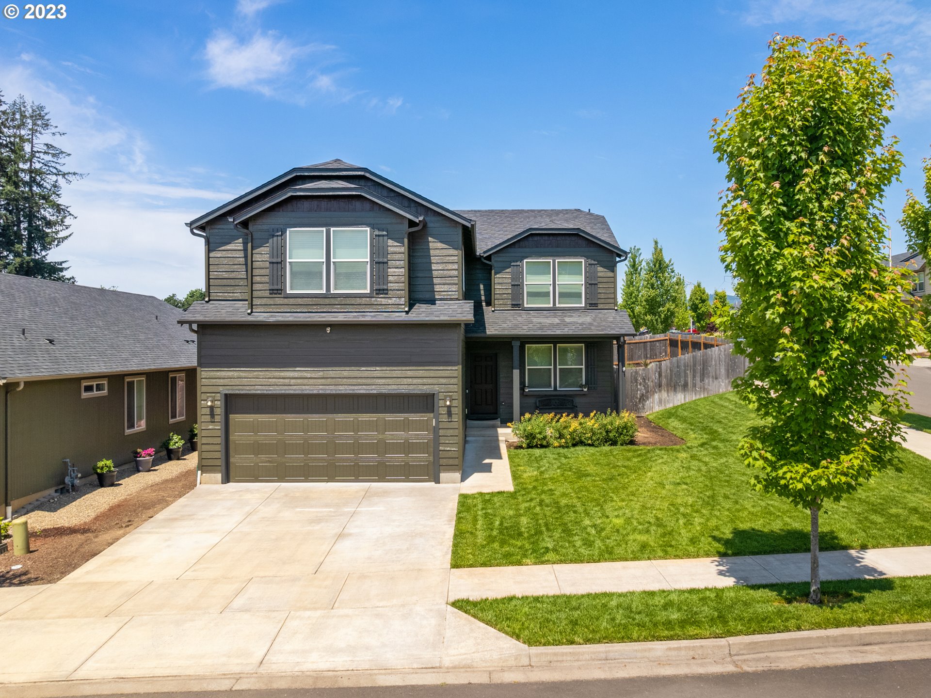 a front view of a house with a garden