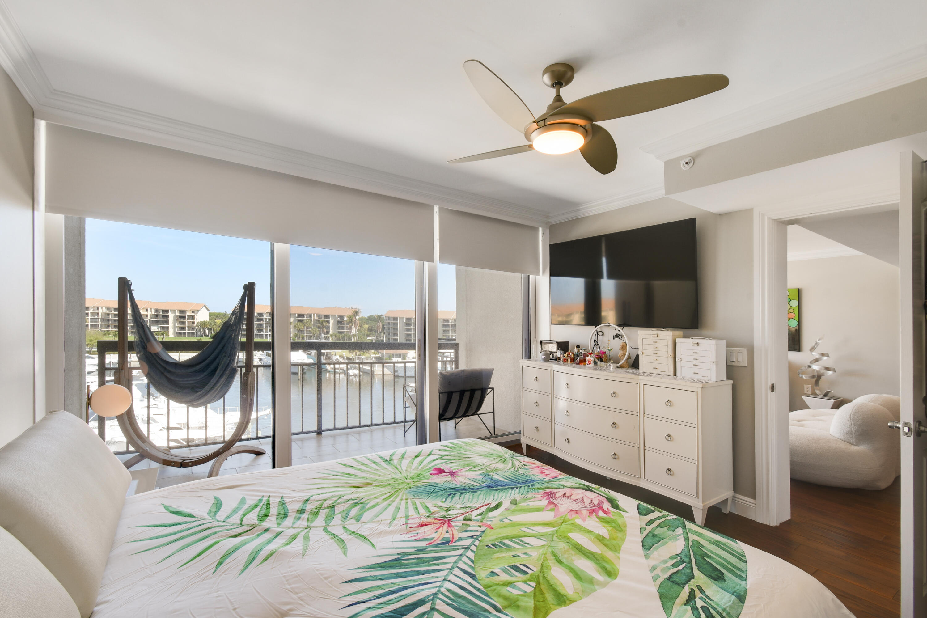 2401 Marina Isle Way, Unit 503 Jupiter, FL 33477 - Photo 19 of 46 a bed room with furniture and a large window