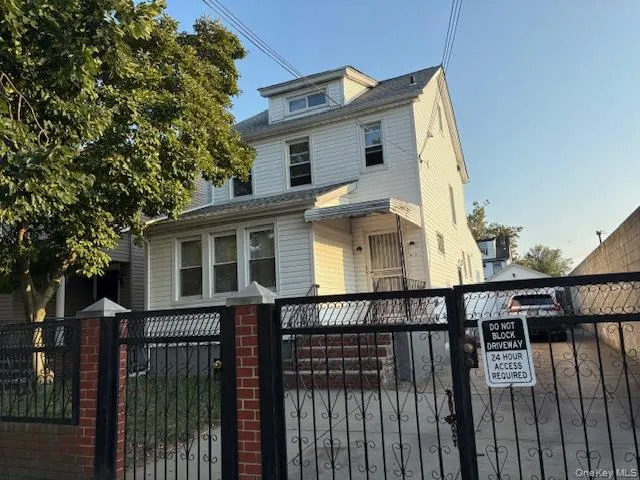 a front view of a house with wooden fence