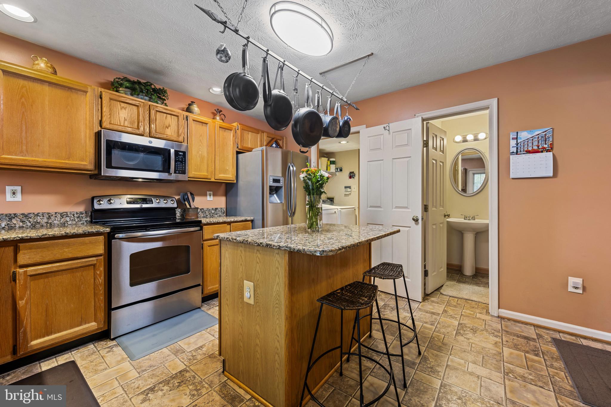 5 Wincrest Court Baltimore, MD 21208 - Photo 11 of 30 a kitchen with stainless steel appliances granite countertop a stove a sink and a microwave