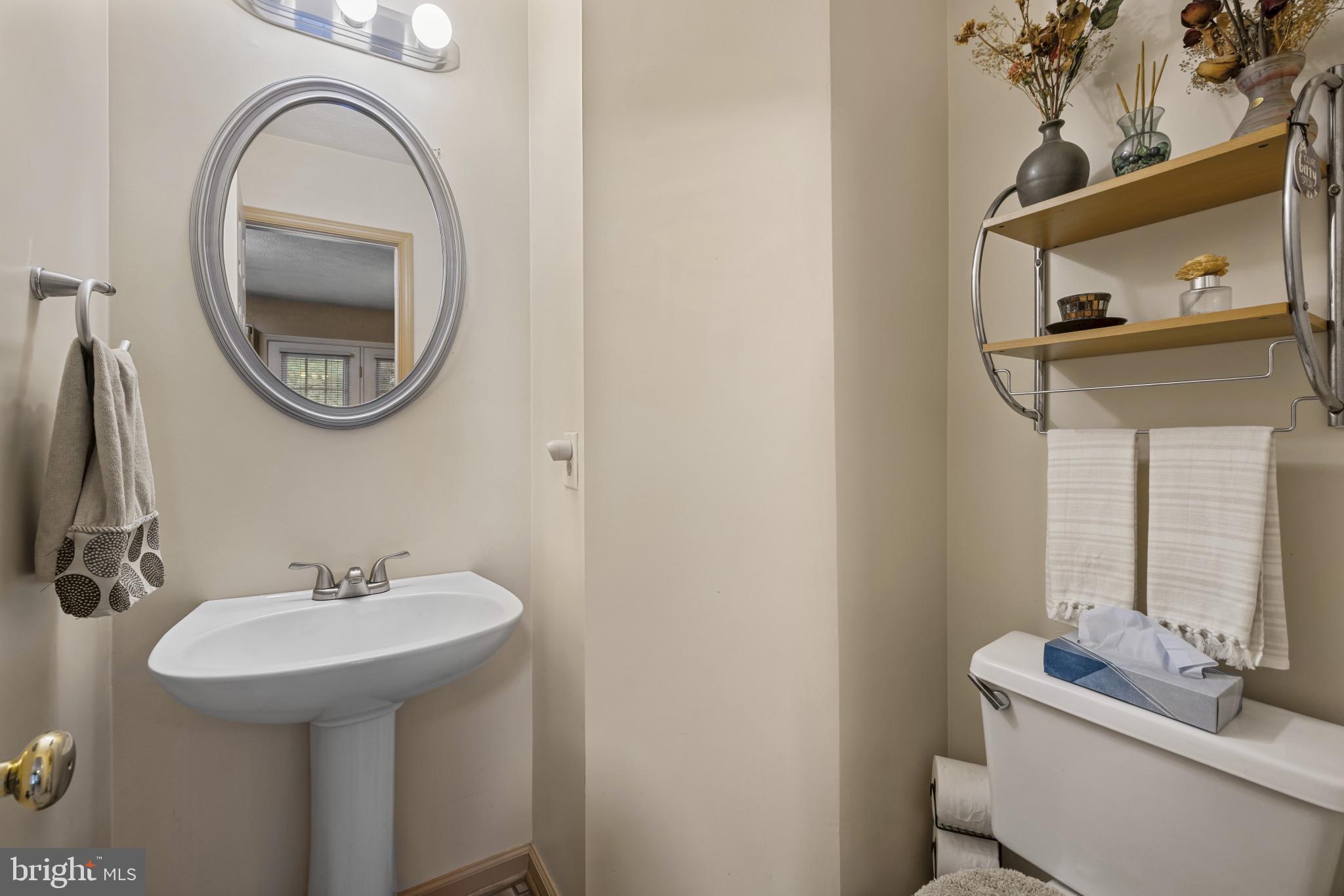 5 Wincrest Court Baltimore, MD 21208 - Photo 15 of 30 a bathroom with a sink a mirror and a toilet