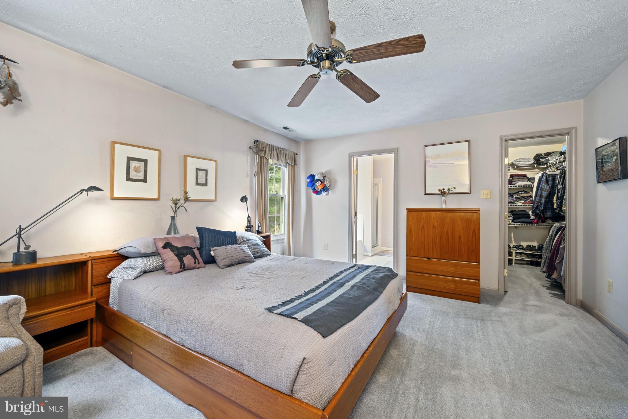 5 Wincrest Court Baltimore, MD 21208 - Photo 22 of 30 a bedroom with bed and a chandelier