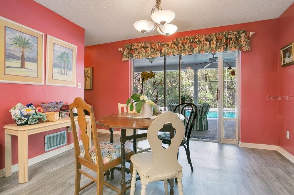 412 Forest Street Windermere, FL 34786 - Photo 6 of 34 a dining room with furniture a chandelier and wooden floor