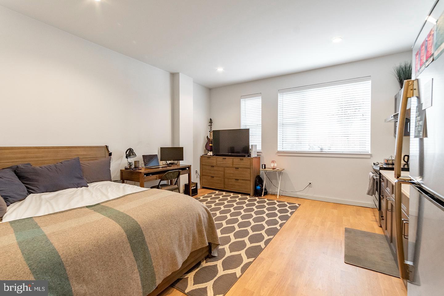 507 South 8th Street, Unit 103 Philadelphia, PA 19147 - Photo 1 of 7 a bedroom with double bed and a flat screen tv