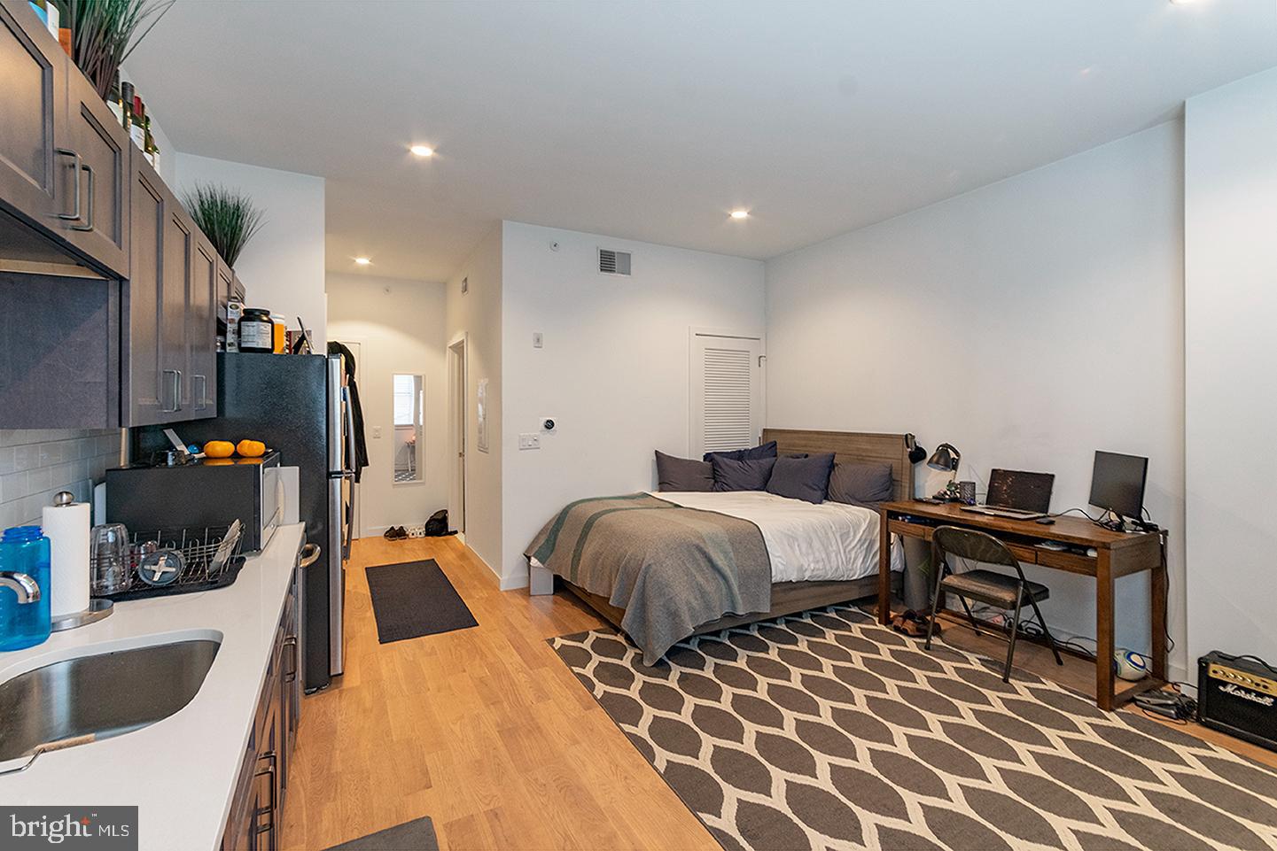 507 South 8th Street, Unit 103 Philadelphia, PA 19147 - Photo 2 of 7 a spacious bedroom with a bed and a couch