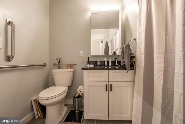 a bathroom with a toilet a sink and a mirror