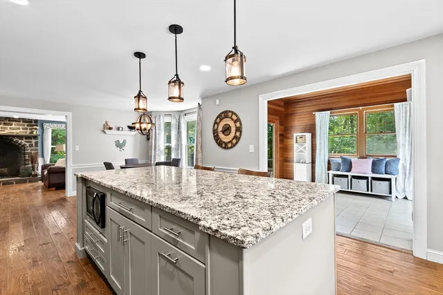a kitchen with a stove and a wooden floor