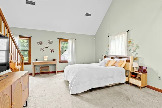 a bedroom with a bed and a table chair