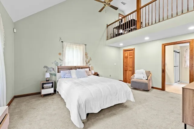 a bedroom with bed and window