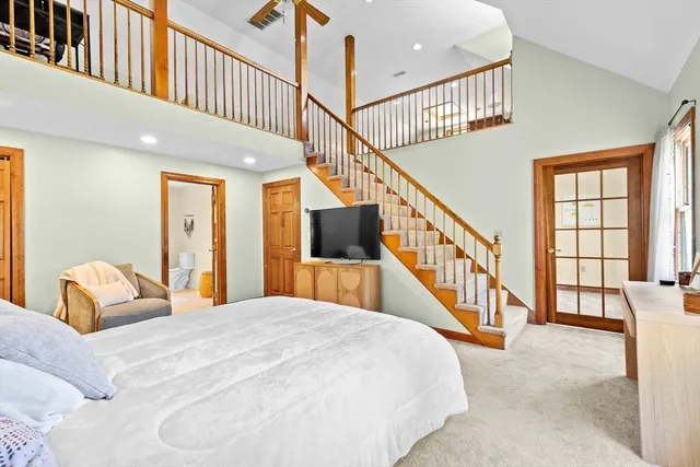 a bedroom with bed and a large window