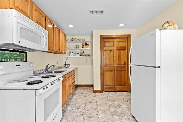 a kitchen with stainless steel appliances granite countertop a refrigerator and a stove