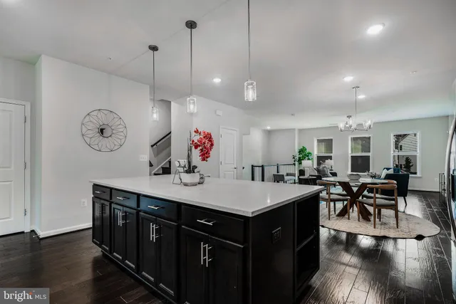 a large kitchen with a table and chairs
