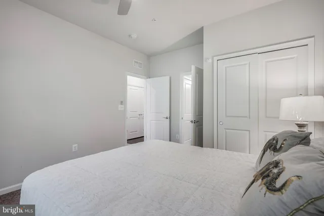 a bedroom with a bed and a lamp