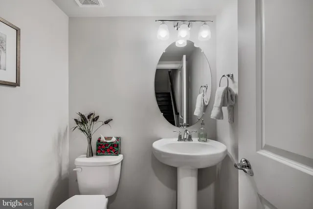 a bathroom with a toilet sink and mirror
