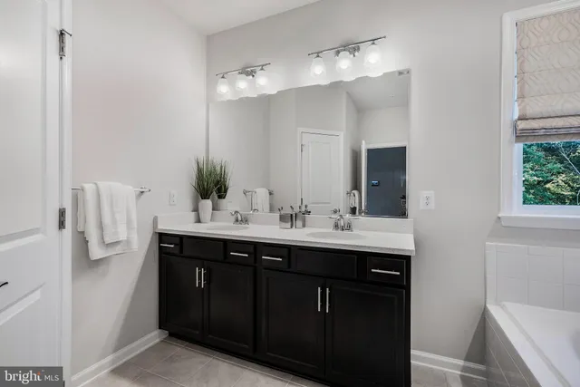 a bathroom with a sink vanity and mirror