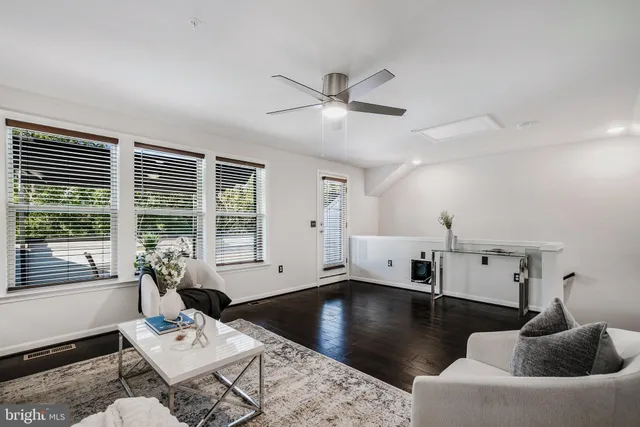 a living room with furniture and window with wooden floor