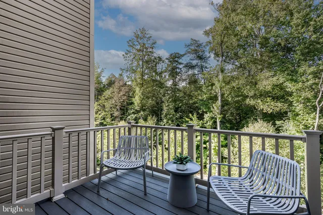 a view of roof deck with chair and wooden floor