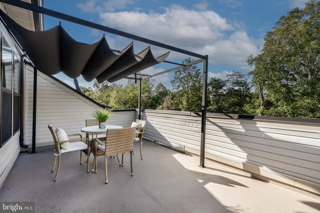 a view of a patio with table and chairs with wooden floor