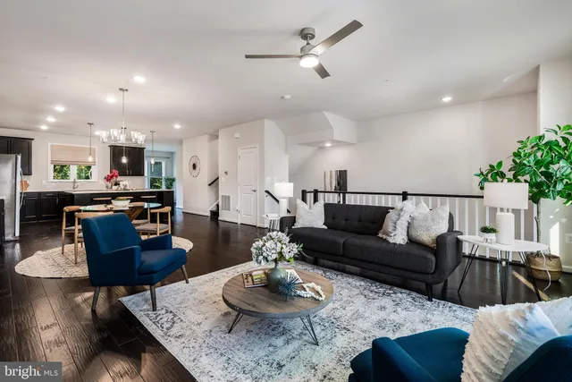 a living room with furniture kitchen view and a table