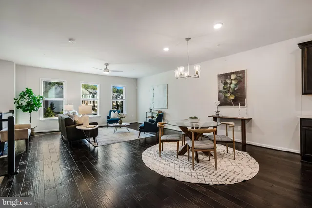 a living room with fireplace furniture and a wooden floor