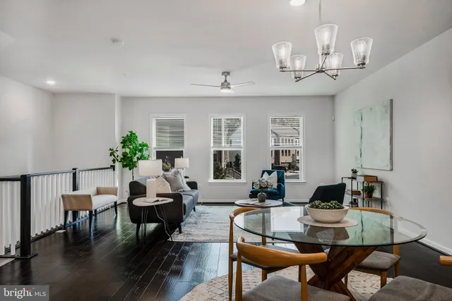 a living room with furniture a window and a chandelier