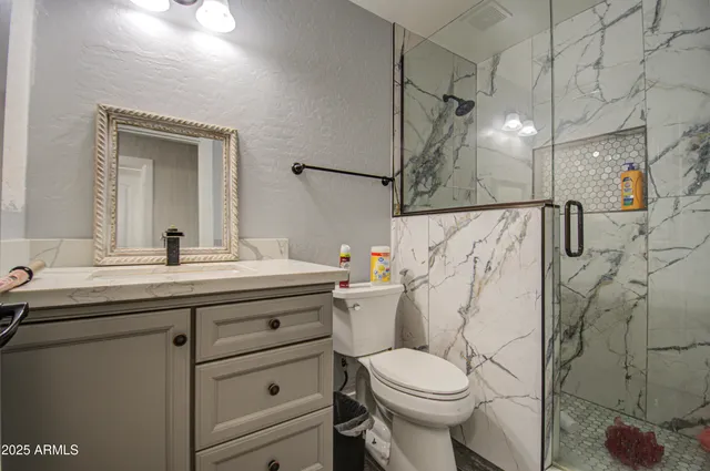 a bathroom with a sink toilet and shower