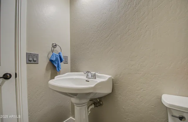 a bathroom with a sink a toilet and mirror