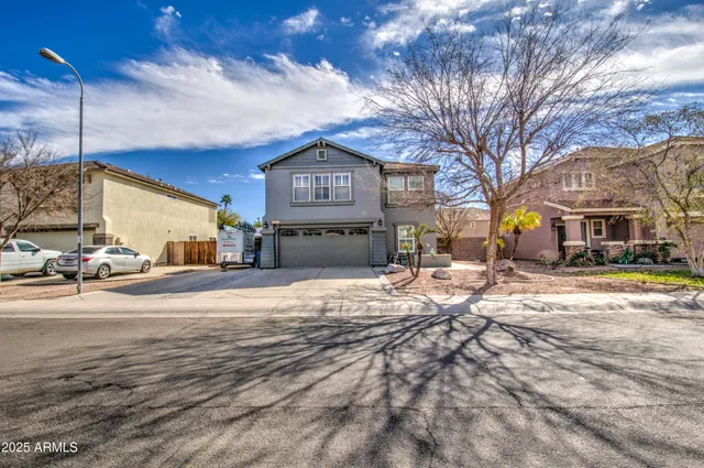 a view of a house with snow on the road