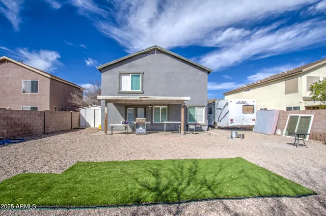 a view of a house with backyard porch and sitting area