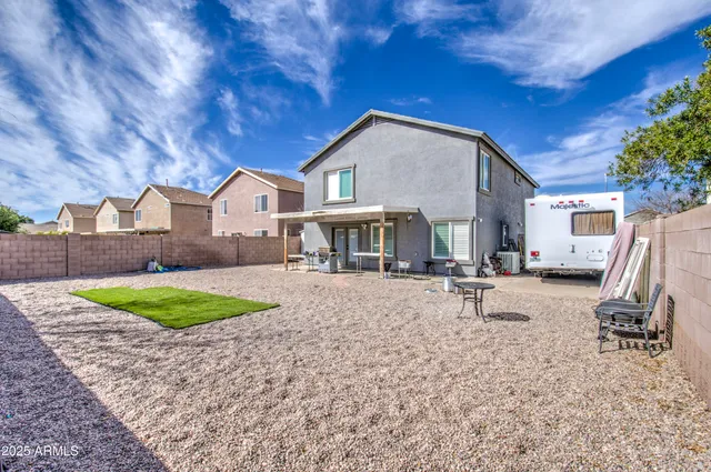 a view of a house with backyard and a tree