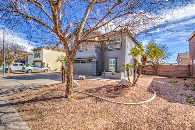a view of a house with snow on the road