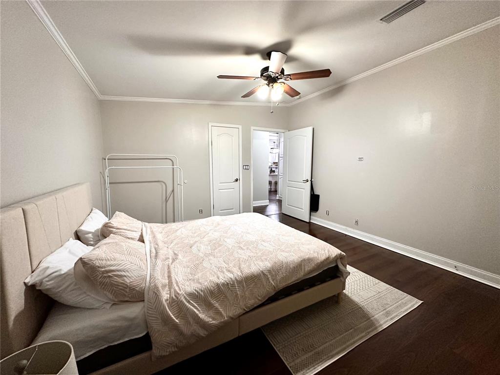 35495 Singletary Road Myakka City, FL 34251 - Photo 17 of 74 a bedroom with a bed and a chandelier